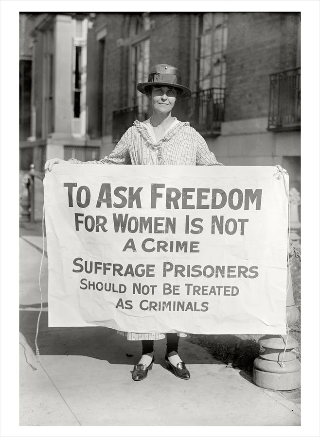 suffragette holding banner with slogan 